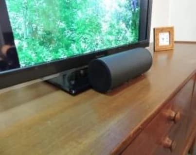 Speakers laid side by side beneath the television, like a single bar