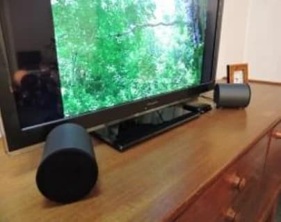 Speakers laid on their side in front of the television